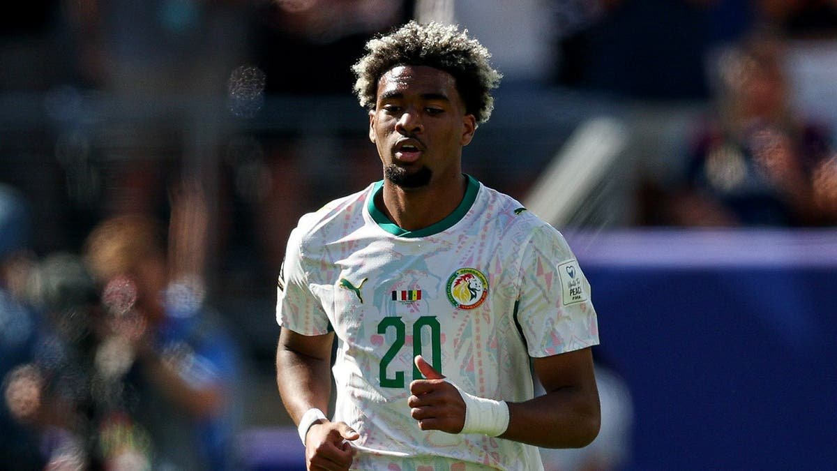 Senegal forward Ibrahim Mbaye running up field after scoring a goal.