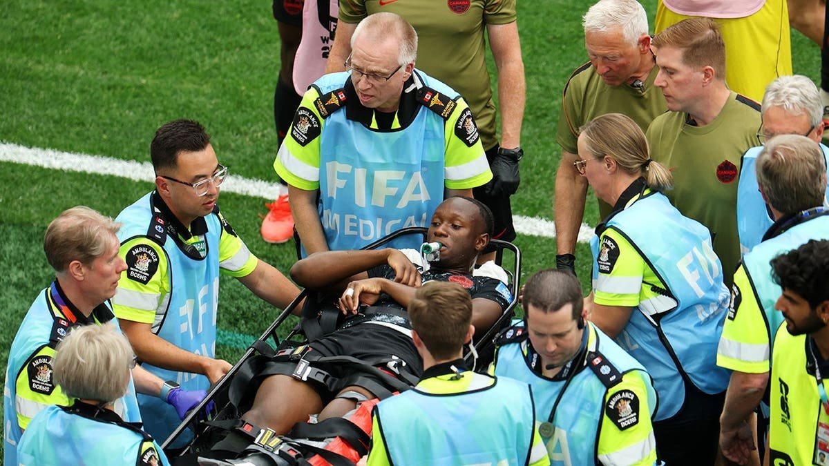 Ismael Kone of Canada stretched off after being fouled by Assim Madibo of Qatar during soccer match