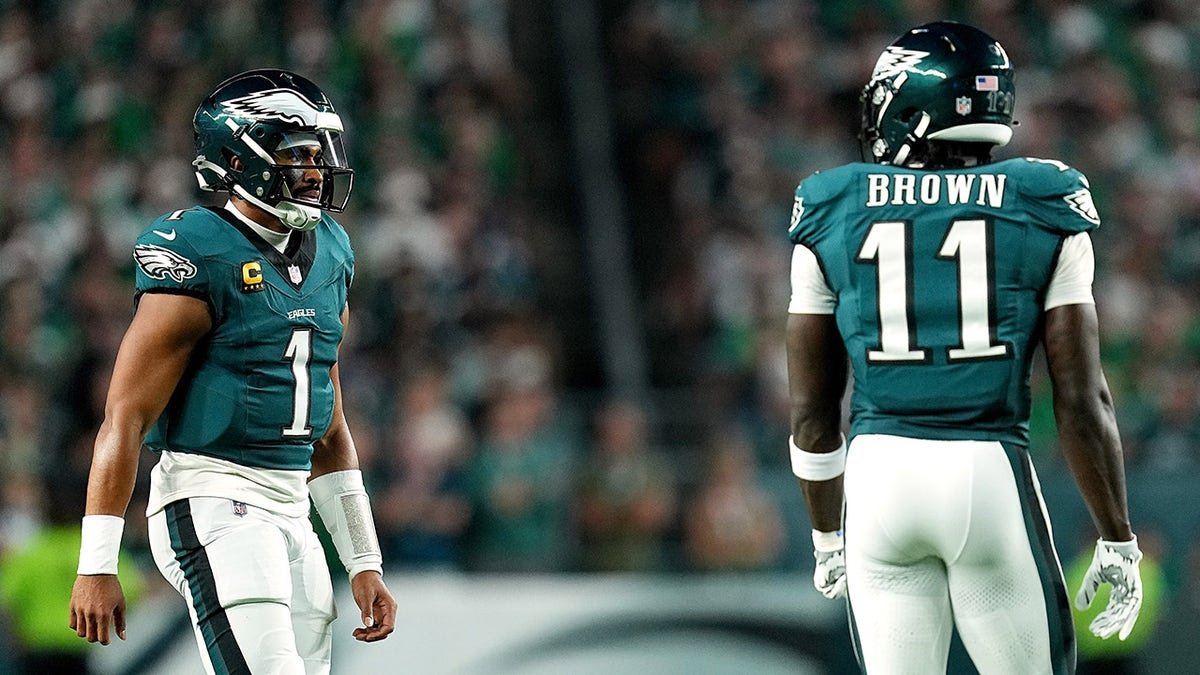 Jalen Hurts and A.J. Brown looking on during a football game at Lincoln Financial Field