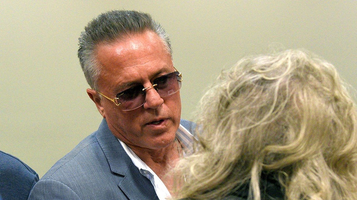 Englishtown Councilman John Alite speaking to a resident outside a municipal building.