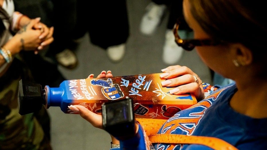 1800 Tequila Knicks bottle in Jordyn Woods' hands