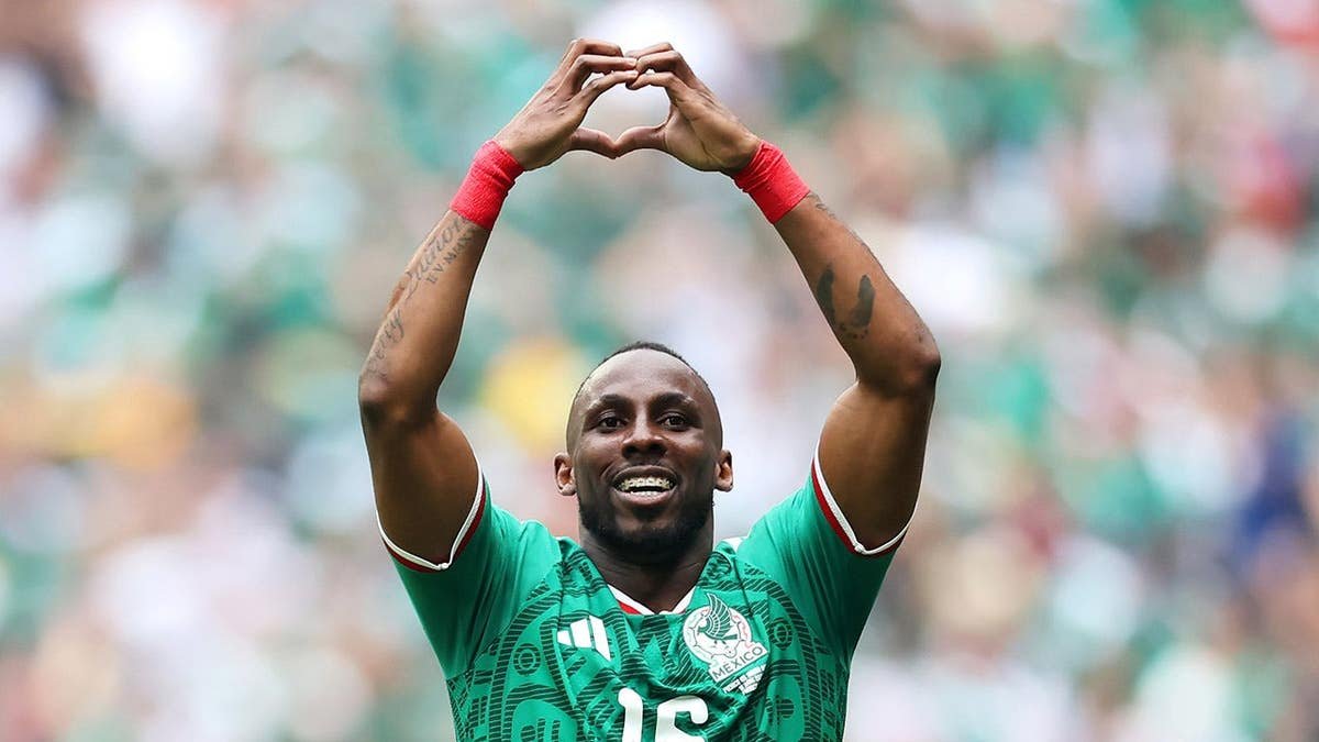 Julian Quinones celebrating after scoring a goal during a soccer match in Mexico City.