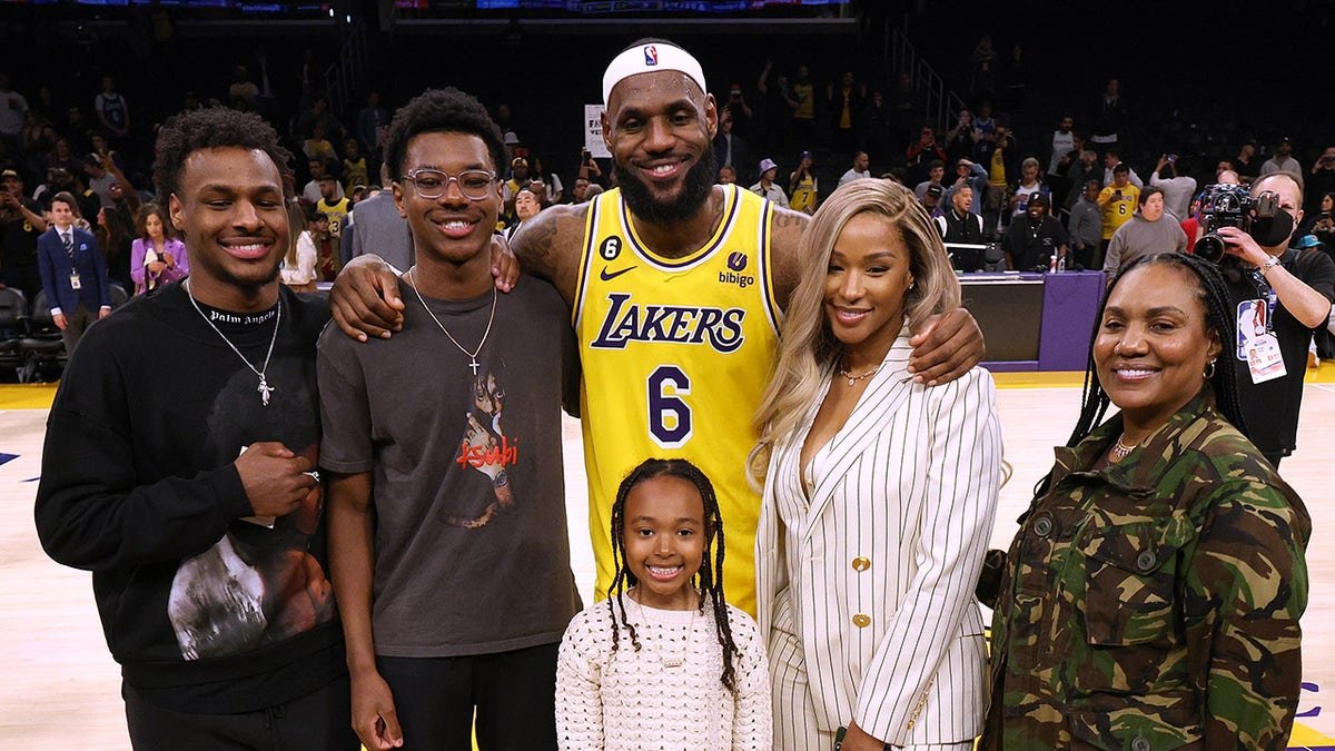 LeBron James posing with his family at Crypto.com Arena in Los Angeles