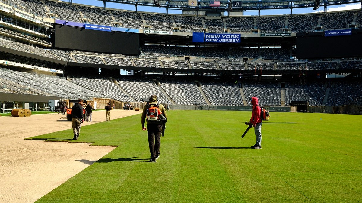 Workers installing the pitch at MetLife Stadium in East Rutherford, New Jersey