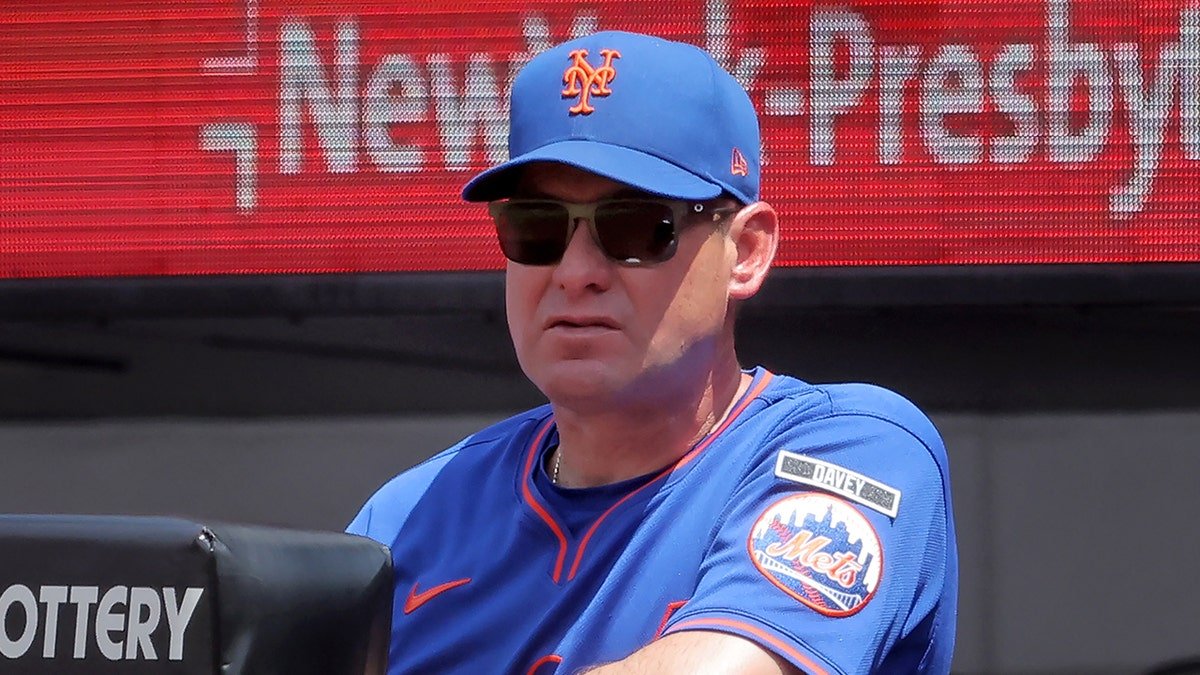 New York Mets manager Carlos Mendoza watching from the dugout at Citi Field.