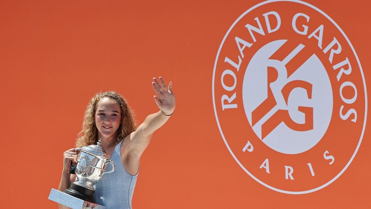 Mirra Andreeva posing with her trophy after winning Roland Garros tennis tournament