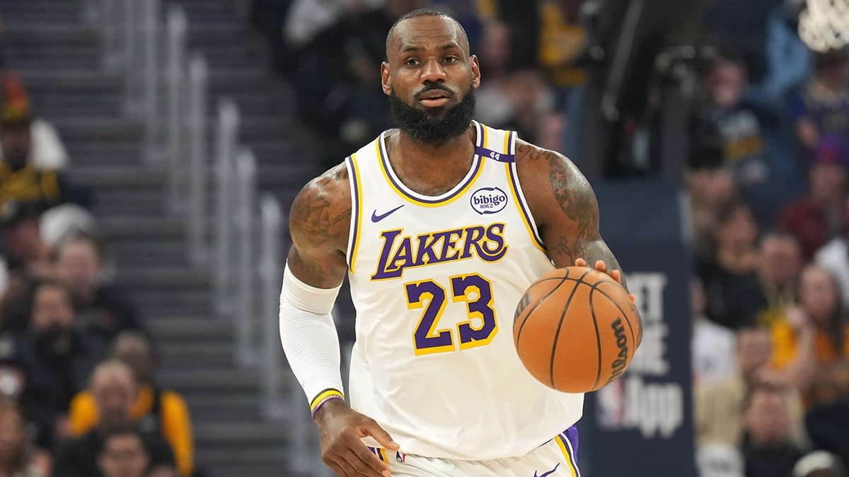 LeBron James dribbling basketball during game at Chase Center