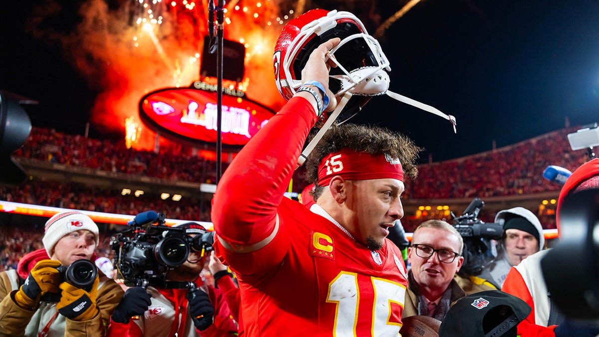 Kansas City Chiefs quarterback Patrick Mahomes taking off his helmet on the field