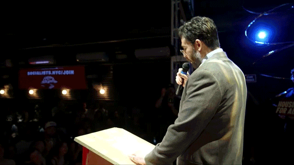 Hasan Piker speaks into a microphone on stage