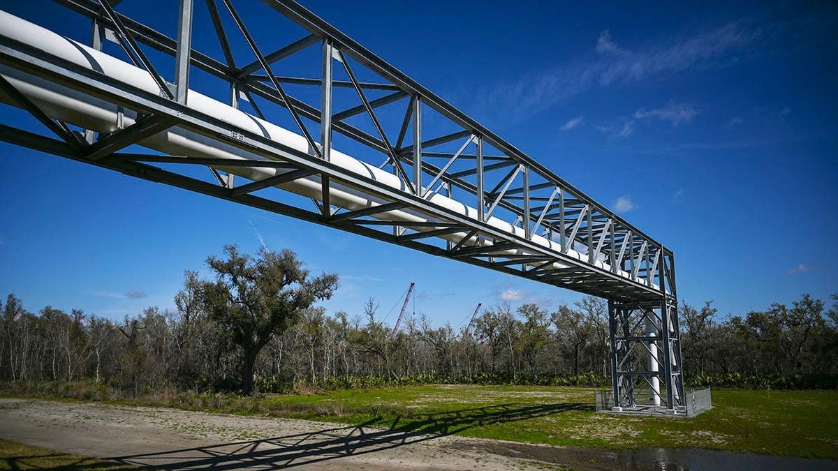 Pipelines raised above levee system at Venture Global's Plaquemines LNG export facility in Port Sulphur Louisiana