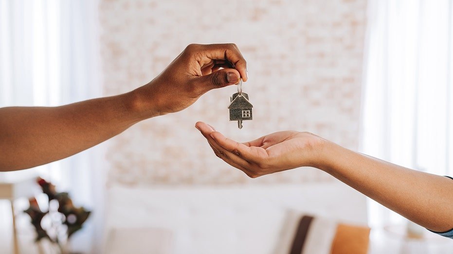 Real estate agent giving a man the keys to his new home