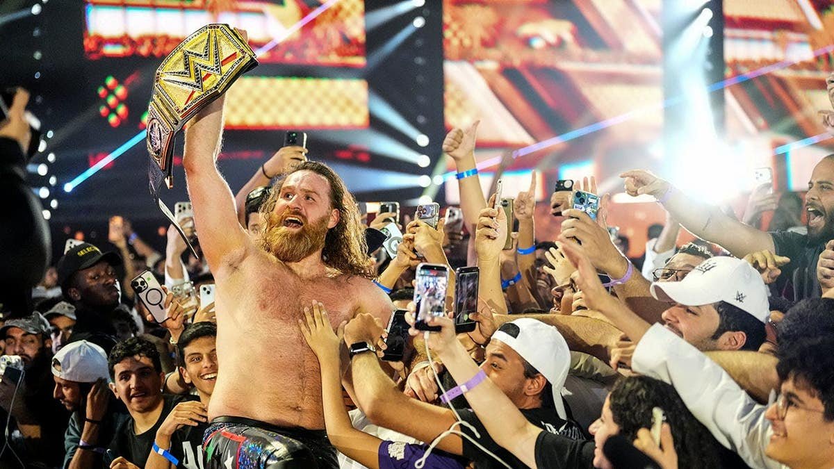 Sami Zayn celebrating with fans at Kingdom Arena in Riyadh, Saudi Arabia.