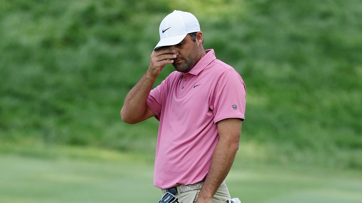 Scottie Scheffler reacting after missing a putt on the 18th green at TPC River Highlands