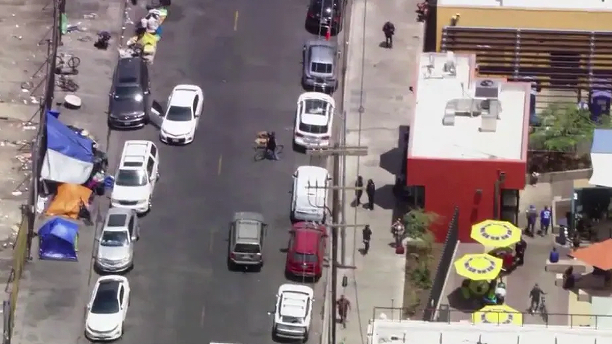Aerial view of the Skid Row Care Campus in downtown Los Angeles, showing homeless encampments and surrounding streets near the county-funded facility