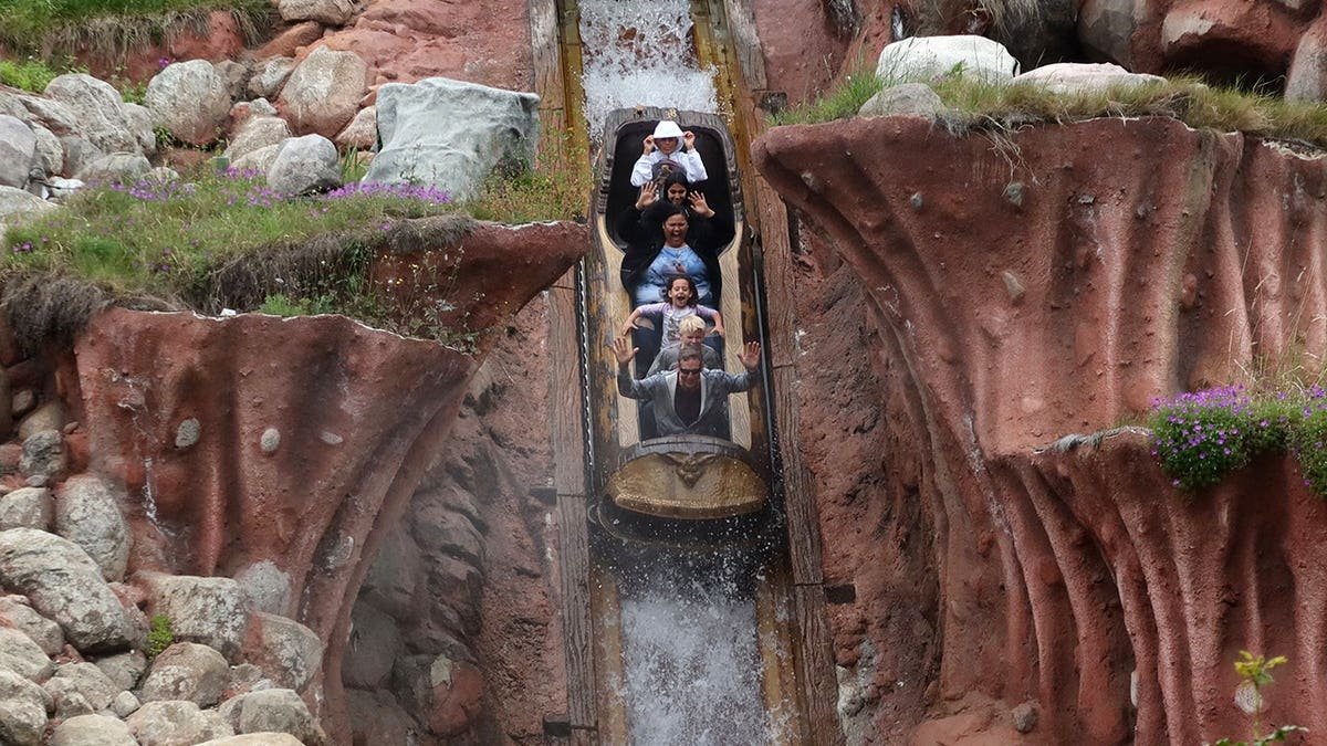 People riding the Splash Mountain attraction at Disneyland in Anaheim, California