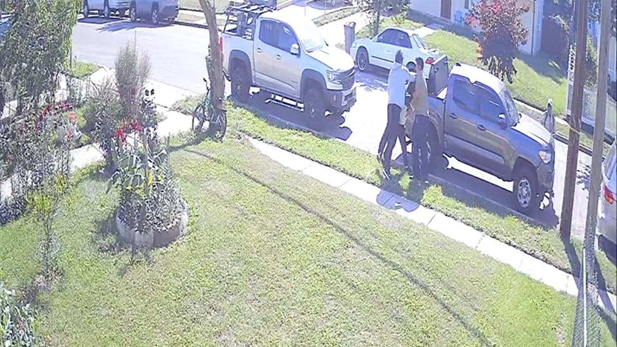 still image of hooded teens allegedly trying to attack a victim