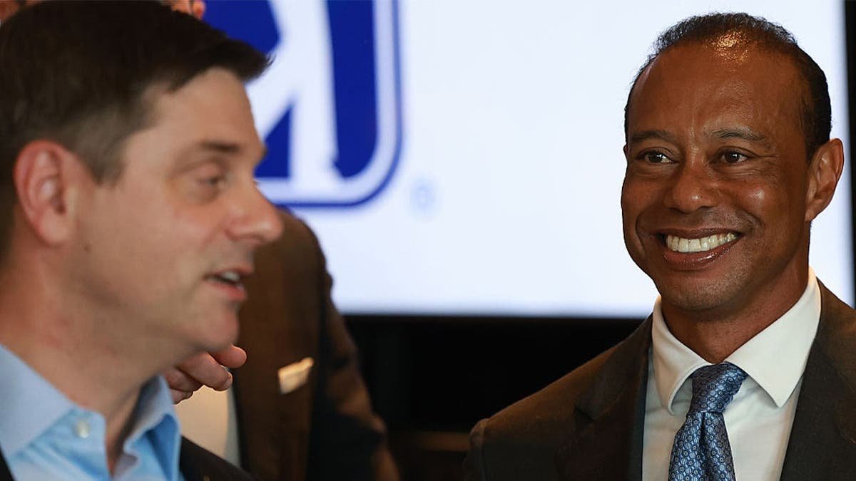 Tiger Woods of the United States looks towards Brian Rolapp