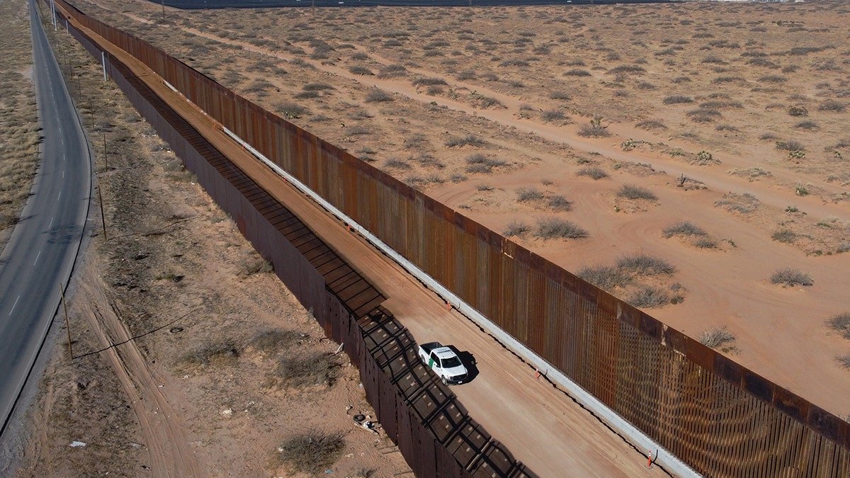 A US Border Patrol pickup parked next to a border wall under construction in Santa Teresa, New Mexico