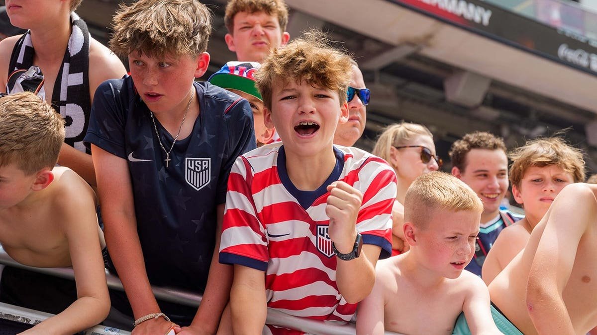 A young American soccer fan cheering at Soldier Field in Chicago