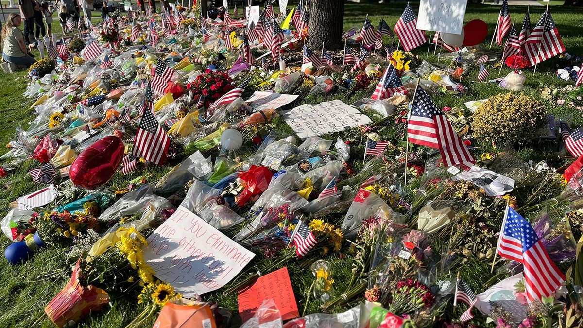 Memorials placed on grass outside Utah Valley University campus during reopening