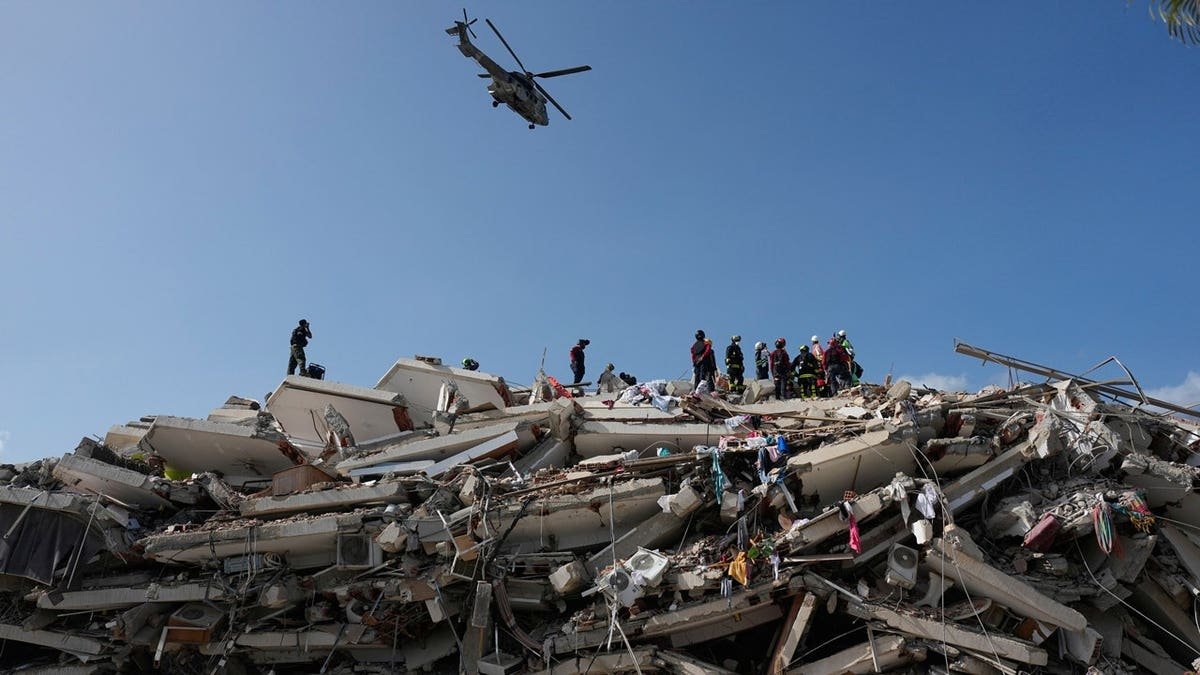 Rescue workers search through the rubble three days after earthquakes struck Catia la Mar, Venezuela