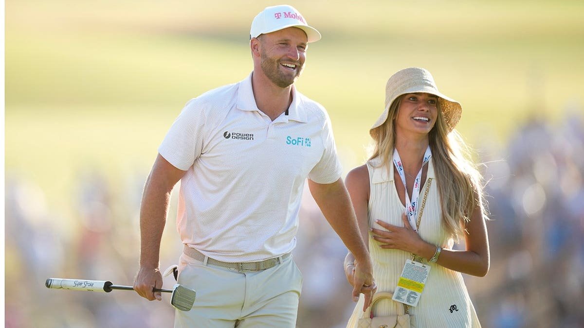 Wyndham Clark standing with his girlfriend Emily Tanner at Shinnecock Hills Golf Club