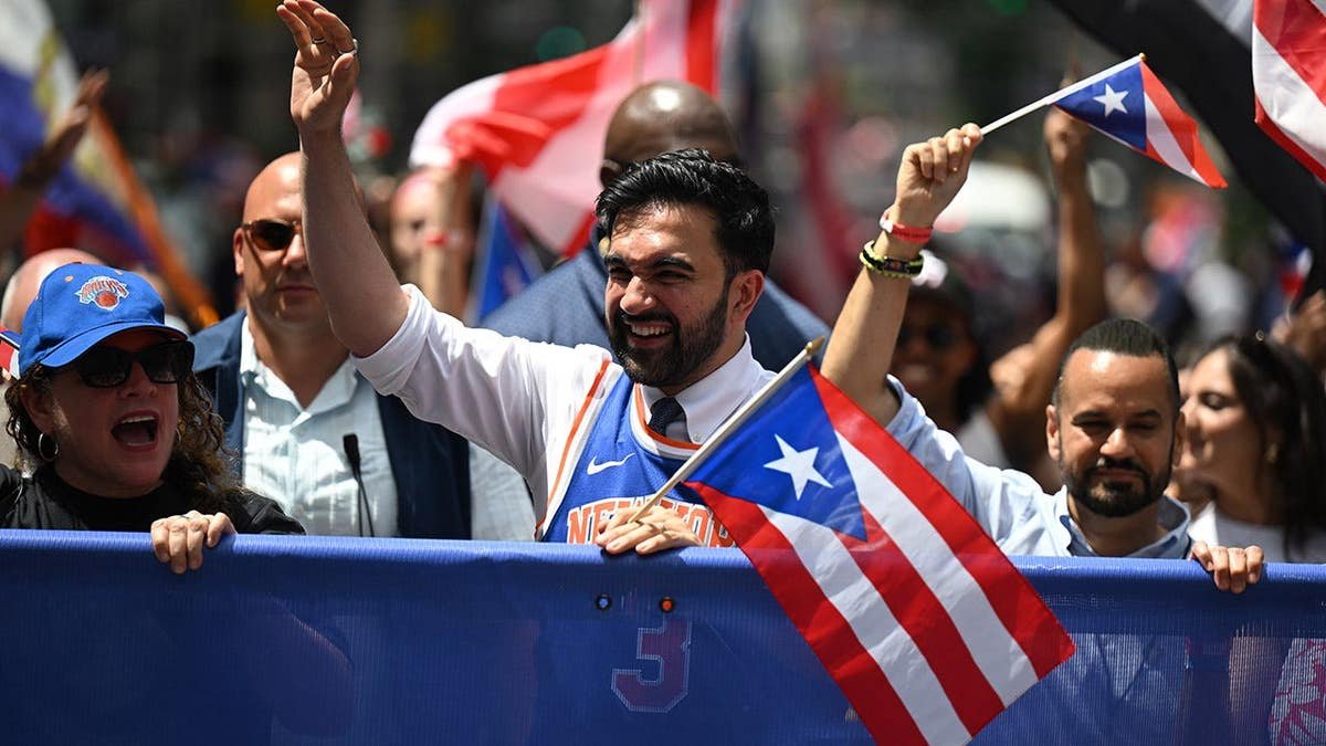 Mayor Zohran Mamdani standing at the National Puerto Rican Day Parade in New York City