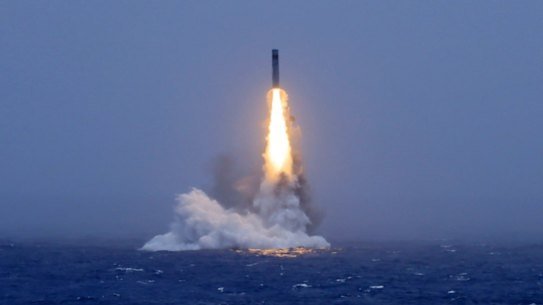 An image published by a Chinese state media outlet shows a missile being launched from a submarine in the South Pacific.