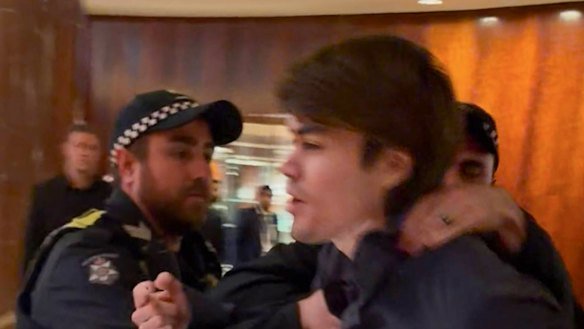 A screenshot of neo-Nazi associate Hugo Lennon being ejected overnight by police from the Melbourne hotel where Indian Prime Minister Narendra Modi was staying.