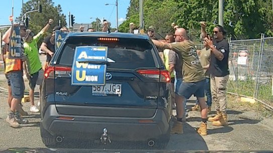 CFMEU members surround an AWU organiser’s car at the Centenary Bridge upgrade site.