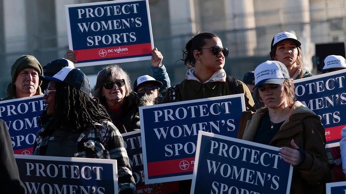 Protesters against transgender athletes competing in women's sports gather outside the Supreme Court in Washington, D.C.