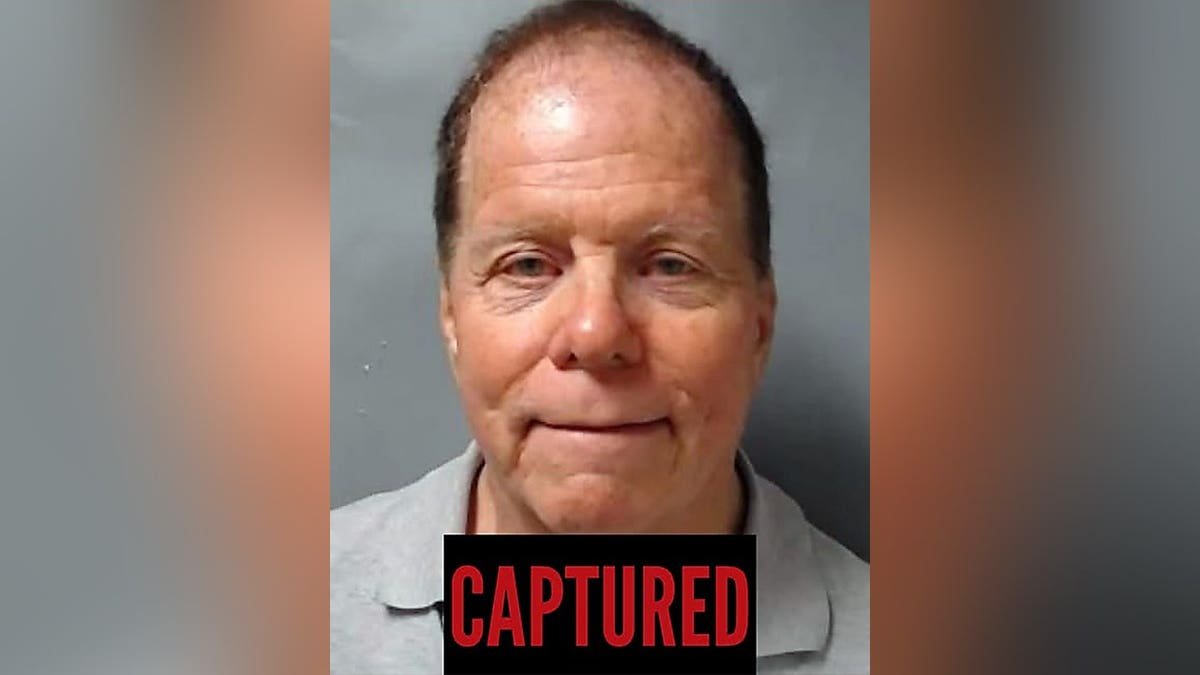 A recent booking-style photo of Ronald L. Fischer with a black