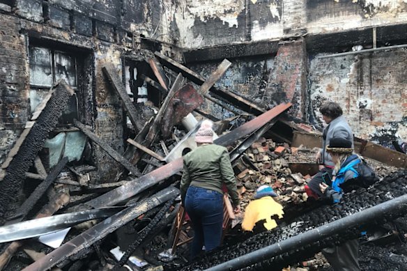 The aftermath of the La Mama Theatre fire in May 2018, which was caused by an electrical fault. Caitlin Dullard is pictured standing on the right.