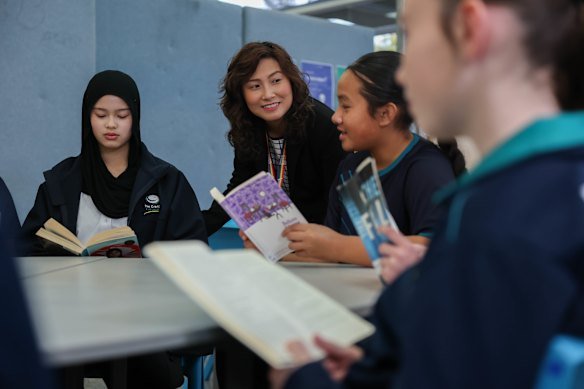 The Grange P-12 College core literacy co-ordinator Clara Tran with year 7 and year 8 students.