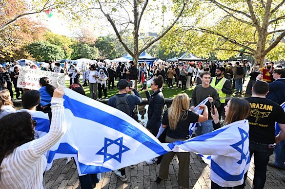 Members of the Jewish community gather opposite a pro-Palestine encampment at the University of Melbourne.