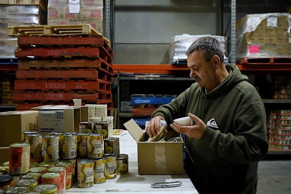 Community leader Mitch Cowan in The Bikers Hand warehouse where boxes of food and household goods are distributed to locals.