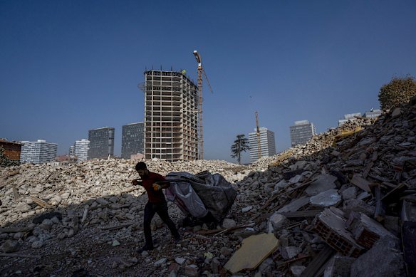 A worker moves debris on a high-rise apartment construction site in Istanbul. 