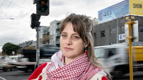 West Melbourne resident Beck Roy at the pedestrian crossing over Dynon Road, which will be removed to speed up traffic coming off the West Gate Tunnel. 