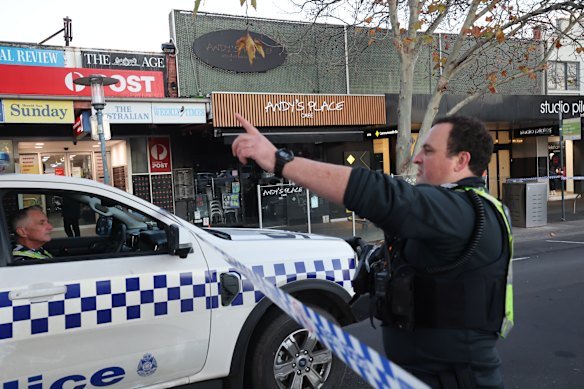 Police at the cafe on Friday after the shooting.