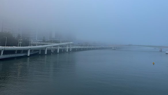 The fog blankets the city along the Brisbane River.