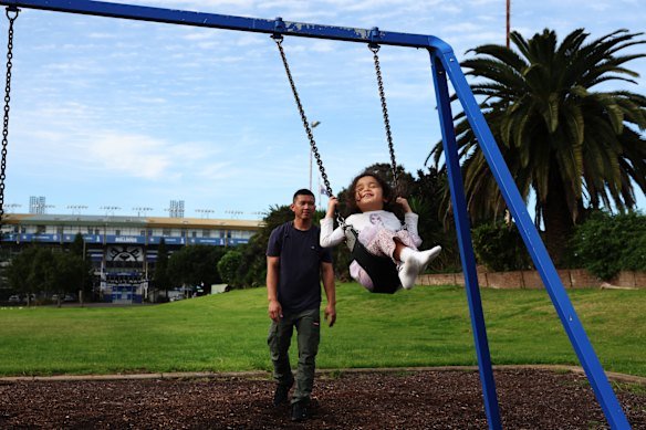 Enjoying the swings at the Terry Lamb Reserve, Belmore.