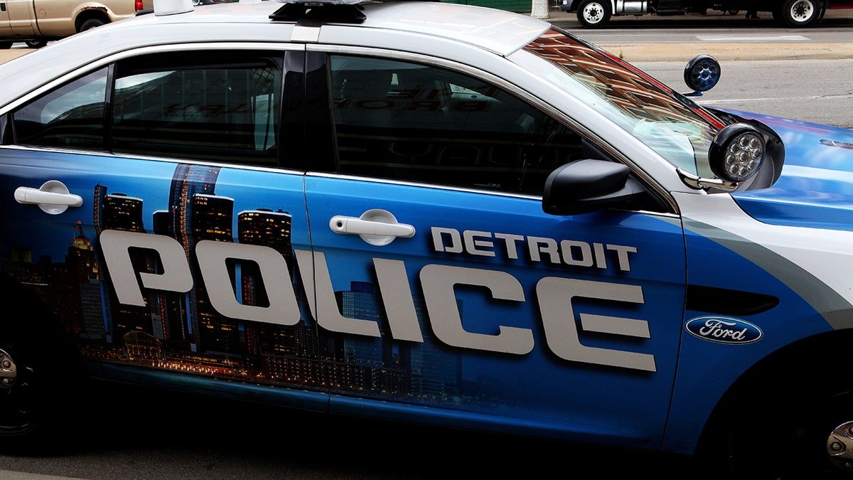 A Detroit police car parked on a downtown street.