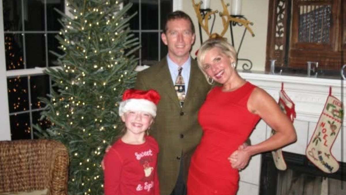 A young Eva Benefield with her parents during the Christmas holiday.