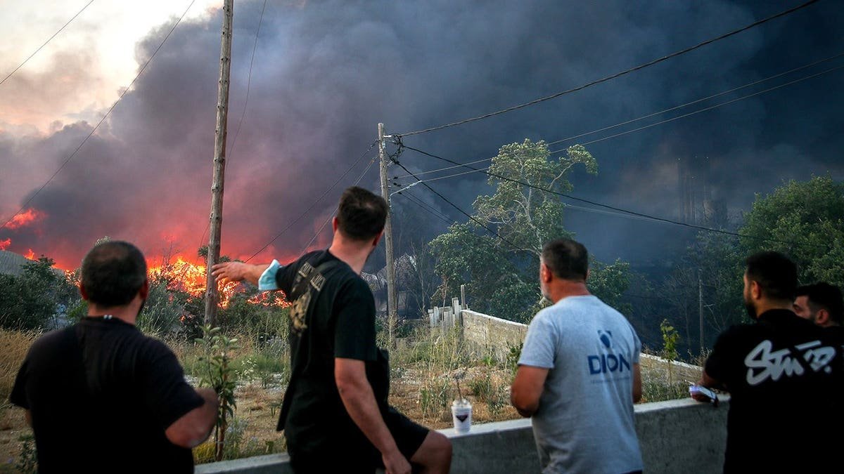 Greek residents viewing wildfire in Thessaloniki earlier in July