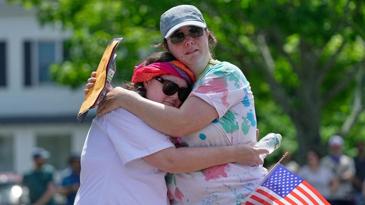 A Maine city counselor hugs a constituent following a shooting