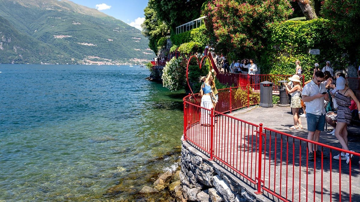 Tourists taking selfies near Lake Como in Varenna