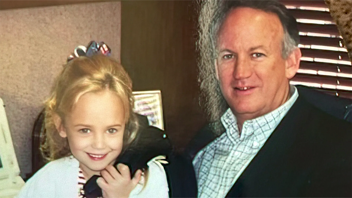 JonBenét Ramsey poses with her father, John Ramsey, in an undated family photograph