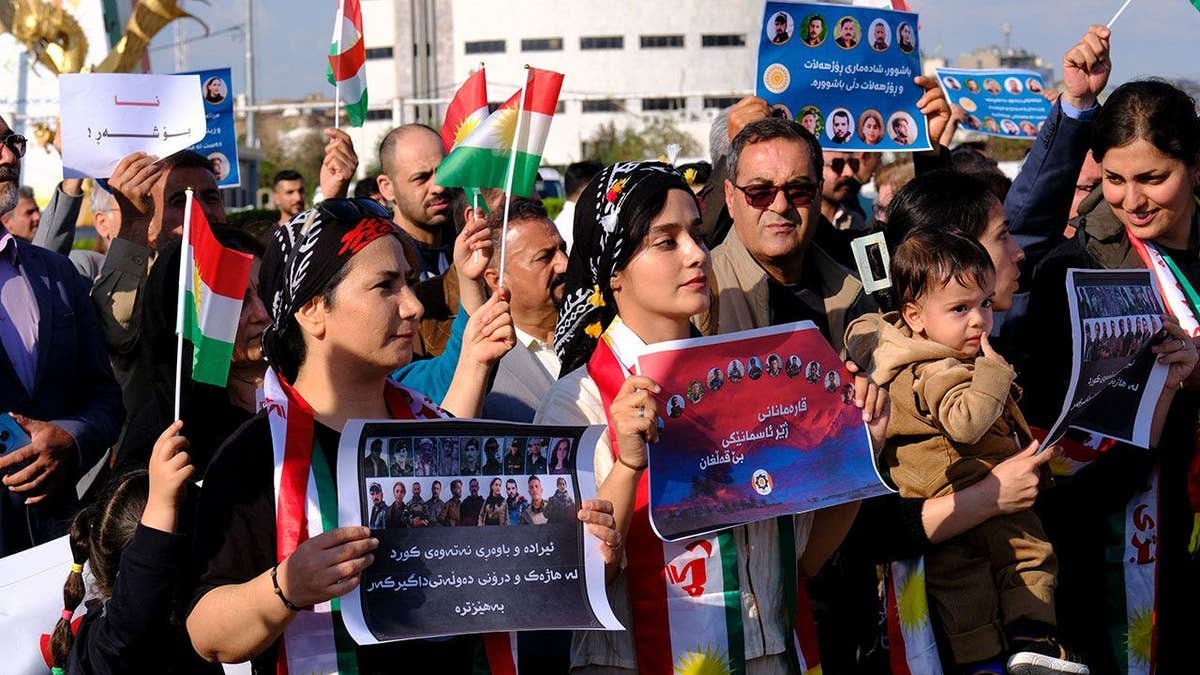 People take part in a march in Erbil, Iraq