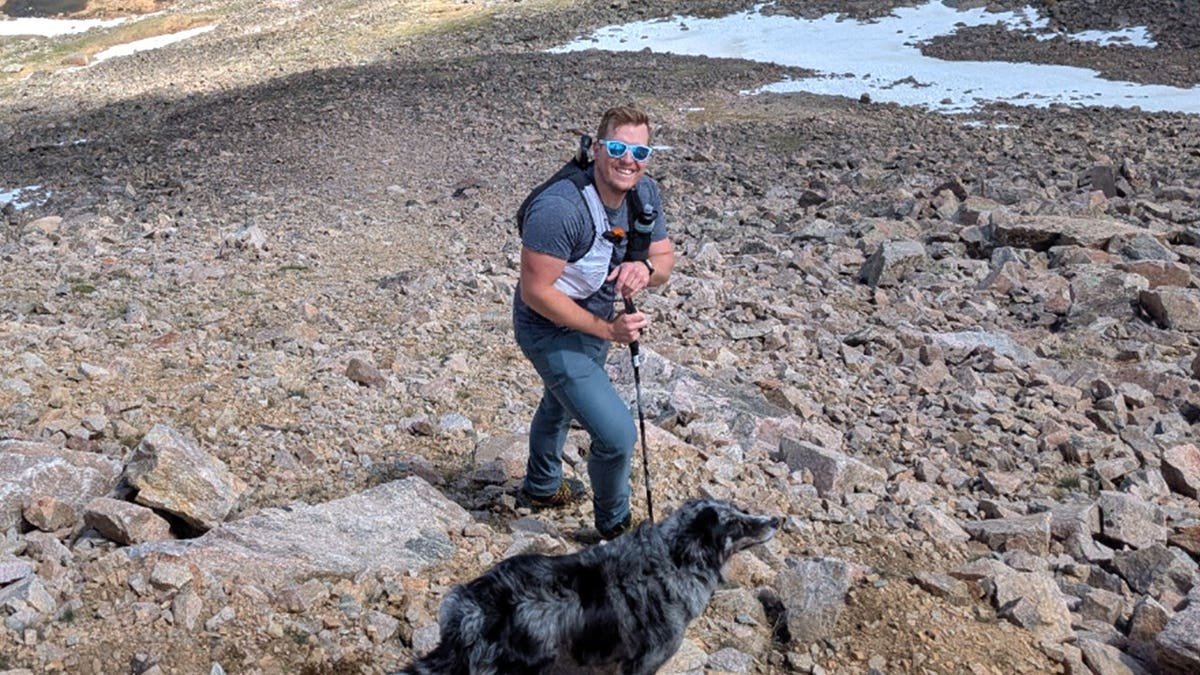 David Cifaldi smiling on hike with dog