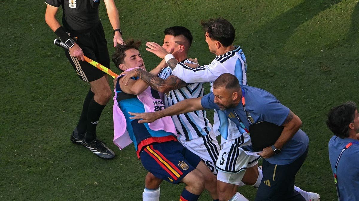 Spain and Argentina players scuffle on the field after the match in East Rutherford.